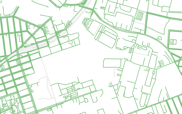 The same place, with green lines for every street and path around the creek's branches, and the highways in gray